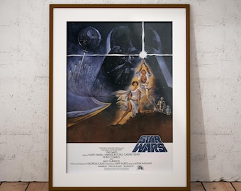 May include: Framed Star Wars movie poster. The artwork features Darth Vader, a Death Star, and characters in a space battle scene. The title "Star Wars" is prominently displayed at the bottom, with the names of the actors and director.