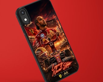 May include: A black smartphone case featuring a graphic print of Lewis Hamilton in a red racing suit, a Formula 1 car, and a helmet. The design includes the text 'Chasing Eternity', 'Legacy Never Stops', 'Driven by Greatness', and the number '44'.