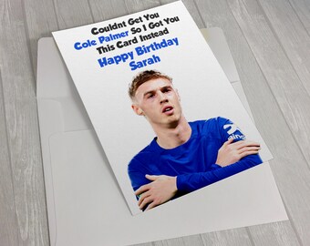May include: A white birthday greeting card featuring a photograph of a person in a blue long-sleeve shirt with arms crossed. The text reads: Couldnt get you Cole Palmer so I got you this card instead Happy Birthday Sarah in black and blue ink.