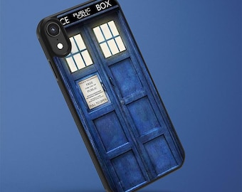 May include: A black phone case featuring a blue police box design with the words "PUBLIC CALL BOX" at the top. The case has a detailed illustration of the box's doors and windows, with a sign that reads "FREE FOR USE OF PUBLIC".