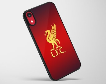 May include: A black smartphone case with a red and black gradient background. The case features a gold Liver Bird emblem and the letters "L.F.C." in gold. The phone's camera lens is visible.