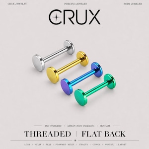 May include: Four flat back labret studs in silver, gold, blue, and green tones. Each piece features a smooth circular front and a flat circular back. The text CRUX, PIERCING JEWELRY, BODY JEWELRY, THREADED, FLAT BACK, and various piercing locations are visible.