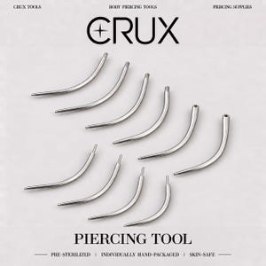 May include: A set of ten silver-colored curved metal piercing tools arranged in two rows. The text CRUX is displayed at the top, with PIERCING TOOL, PRE-STERILIZED, INDIVIDUALLY HAND-PACKAGED, and SKIN-SAFE printed at the bottom of the image.