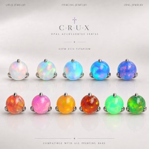 May include: Eleven spherical opal piercing jewelry attachments arranged in two rows. Each piece features a round, multi-colored opal set in a metallic base. Text reads: CRUX JEWELRY, PIERCING JEWELRY, OPAL JEWELRY, C+R+U+X, OPAL ACCESSORIES SERIES, ASTM F136 TITANIUM, COMPATIBLE WITH ALL PIERCING BARS.