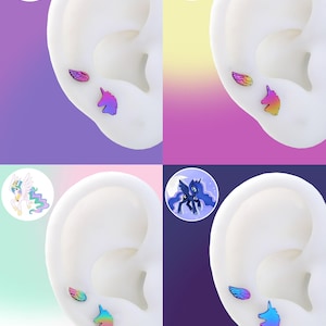May include: A set of four pairs of stud earrings featuring a wing and a unicorn head design. The earrings are in various colors, including purple, blue, and yellow. Each pair is displayed on a white ear model with a cartoon pony in the background.