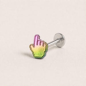 May include: A labret stud body jewelry piece featuring a pixelated hand cursor charm. The charm has a metallic gradient finish transitioning from pink at the top to yellow and green at the base. It is attached to a straight silver-toned post.