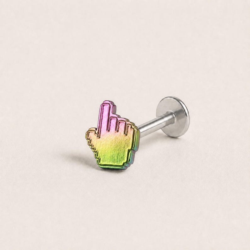 May include: A labret stud body jewelry piece featuring a pixelated hand cursor charm. The charm has a metallic gradient finish transitioning from pink at the top to yellow and green at the base. It is attached to a straight silver-toned post.