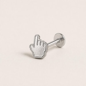 May include: A silver-toned metal body jewelry stud featuring a flat, pixelated computer cursor hand icon at the front. The piece includes a straight post and a circular flat back disc, designed for secure placement in a piercing.