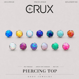 Puede incluir: Trece piezas superiores para piercing redondas con cabujones de estilo ópalo de colores engastados en monturas de metal plateado. La imagen incluye el texto CRUX JEWELRY PIERCING JEWELRY REPLACEMENT END arriba y PIERCING TOP BODY JEWELRY abajo.