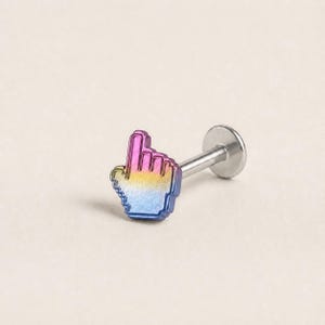 May include: A labret stud body jewelry piece featuring a flat back and a front charm shaped like a computer mouse cursor hand. The charm has a gradient finish transitioning from purple at the top to yellow in the middle and blue at the bottom.