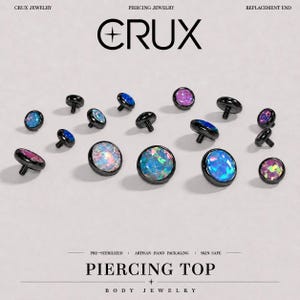 May include: A collection of round piercing jewelry replacement ends featuring black metal settings and iridescent, multi-colored opal-style cabochon stones. The text CRUX PIERCING JEWELRY REPLACEMENT END and PIERCING TOP BODY JEWELRY is visible.
