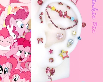 May include: An assortment of pink and rose gold ear piercings, including studs, a chain, and a bar. The piercings feature star, bow, and heart shapes, with a pink background and the text "Pinkie Pie".