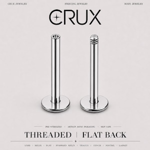 May include: Two silver-colored metal flat back piercing studs with threaded posts. The text CRUX PIERCING JEWELRY BODY JEWELRY is at the top, and THREADED FLAT BACK with LOBE HELIX FLAT FORWARD HELIX TRAGUS CONCH NOSTRIL LABRET is at the bottom.
