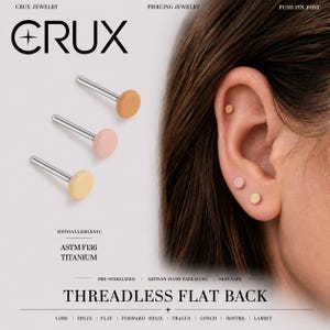 May include: Three threadless flat back piercing studs with round, matte-finish tops in peach, light pink, and cream colours. The studs feature silver-toned posts and are labelled as ASTM F136 titanium. The text CRUX JEWELRY is visible.