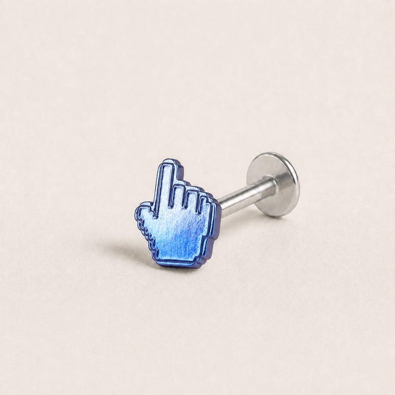 May include: A body jewelry stud featuring a metallic blue cursor hand icon as the decorative top. The piece includes a straight silver-toned post and a flat circular backing, designed for secure placement in a piercing with a clean finish.