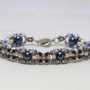 May include: A beaded bracelet with a silver clasp. The bracelet features blue, white, and pink beads, as well as dark blue and silver beads.