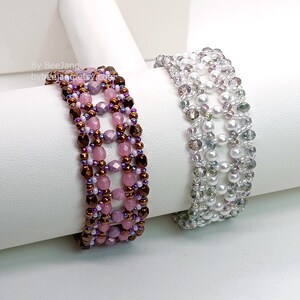 Two wide, handcrafted beaded cuff bracelets are displayed on a white stand, showcasing an intricate Right Angle Weave lattice design. Both pieces are meticulously woven with faceted bicone crystals, smooth round pearls, and delicate seed beads.

    Left: A warm palette of pink and lavender beads accented by dark metallic bronze rounds.
    Right: A monochromatic, elegant look featuring translucent clear crystals and lustrous white pearls.