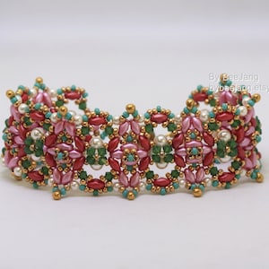 May include: A beaded bracelet featuring a floral design in shades of pink, red, green, and gold. The bracelet is crafted with small seed beads and showcases a repeating pattern of flowers.