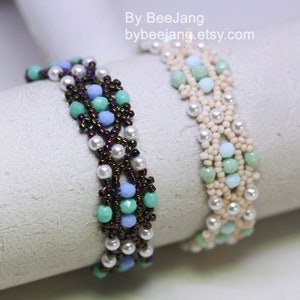 May include: Two beaded bracelets with a woven design. One bracelet is made with white, light blue, and green beads. The other bracelet is made with white, light blue, and dark brown beads. The bracelets are on a white surface. By BeeJang bybeejang.etsy.com