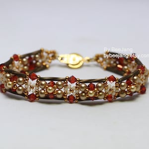 May include: A beaded bracelet with a gold clasp. The bracelet is made with brown, white, and red beads.