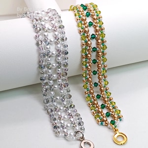 Two wide, handcrafted beaded cuff bracelets are draped over a white stand, showcasing an intricate Right Angle Weave lattice design. Each piece is woven with faceted bicone crystals, smooth round pearls, and seed beads, secured with a metallic toggle clasp.

    Left: Clear crystals and white pearls with a silver clasp.
    Right: Emerald and olive green crystals with gold-toned pearls and a gold clasp.