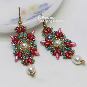 May include: A pair of dangle earrings with a geometric design featuring red, pink, gold, turquoise, and white beads. The earrings have a pearl drop.