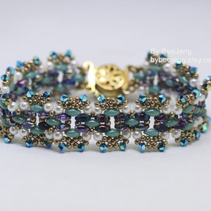 May include: A beaded bracelet with a gold clasp. The bracelet is made with a variety of colours, including teal, purple, white, and gold.