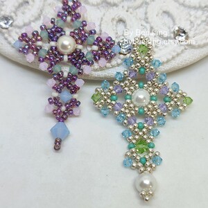 Chrisia pendants in two colors. One is in silver, green peridot and light blue. The other is in purple, blue, pink and pacific opal.