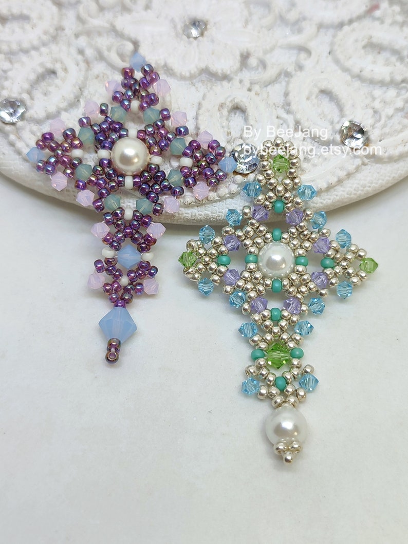Chrisia pendants in two colors. One is in silver, green peridot and light blue. The other is in purple, blue, pink and pacific opal.