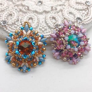 Ceres pendants in two colors. One is in copper, blue and beige. The other is in pink, purple and silver.