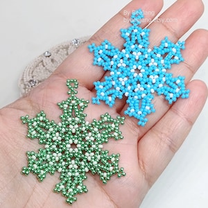 May include: Two beaded snowflake ornaments, one blue and white, and one green and white.