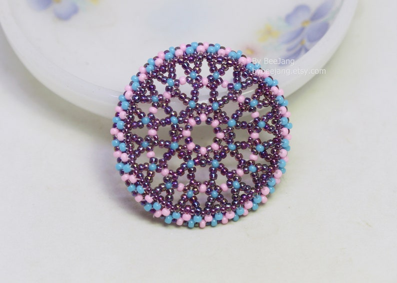 Olwyn wheel pendant in purple, pink and blue.