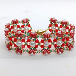 May include: A decorative bracelet with a floral pattern, made with red, white, gold, and turquoise beads. The bracelet has a gold clasp. The beads are small and round, with larger pearl-like beads.