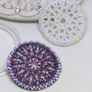 Olwyn wheel pendants in two colors. One is white and mix pastel. The other is purple, pink and blue.