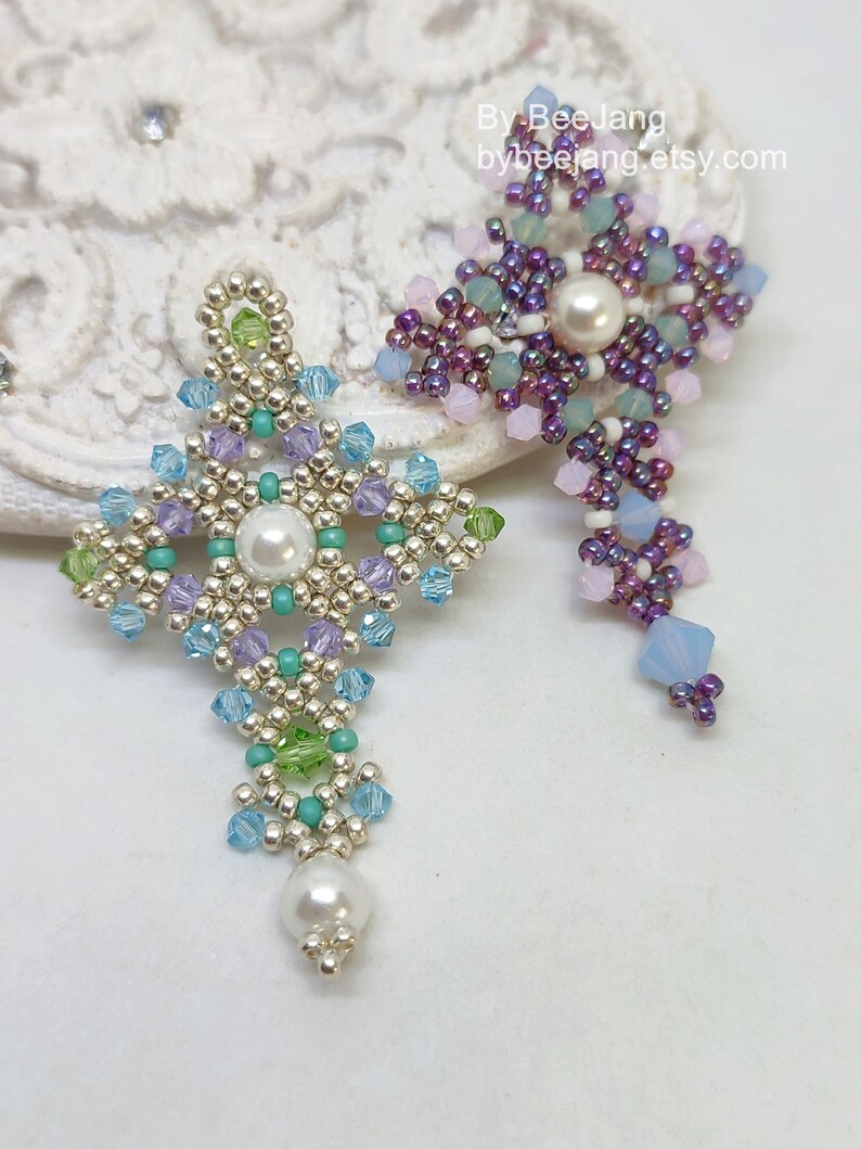 Chrisia pendants in two colors. One is in silver, green peridot and light blue. The other is in purple, blue, pink and pacific opal.