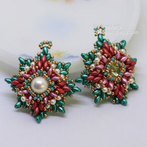 May include: A pair of star-shaped earrings with a beaded design in shades of green, pink, and red. The earrings feature a large pearl bead in the centre and a smaller, clear gemstone bead.