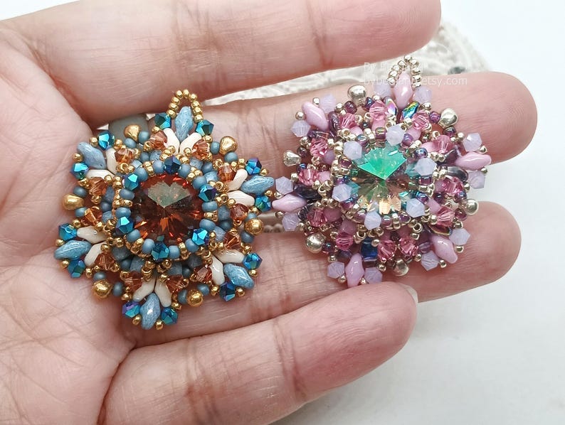 Ceres pendants in two colors. One is in copper, blue and beige. The other is in pink, purple and silver.