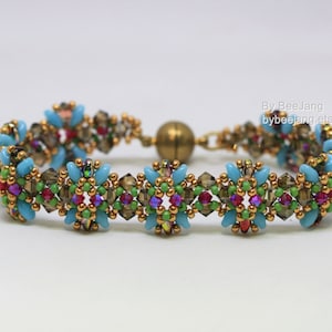 May include: A beaded bracelet with a magnetic clasp. The bracelet features turquoise, brown, green, red, and purple beads, with gold-colored accents. The text "By BeeJang bybeejang.etsy.com" is visible.