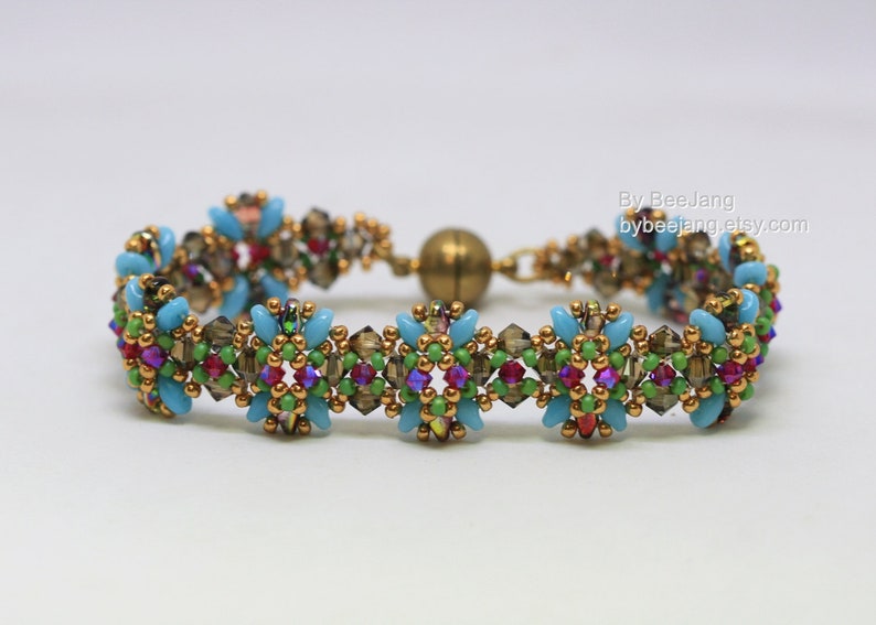 May include: A beaded bracelet with a magnetic clasp. The bracelet features turquoise, brown, green, red, and purple beads, with gold-colored accents. The text "By BeeJang bybeejang.etsy.com" is visible.