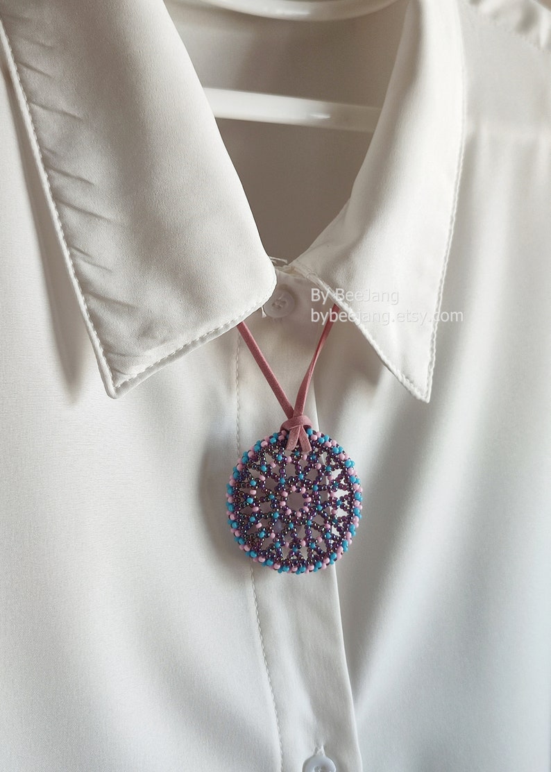 Olwyn wheel pendant in purple, pink and blue.