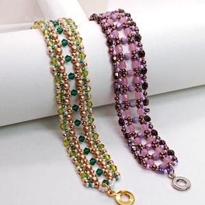 Two wide, handcrafted beaded cuff bracelets are shown with an intricate
Right Angle Weave lattice design. Each piece is meticulously woven with faceted bicone crystals, smooth round pearls, and delicate seed beads, secured with a metallic toggle clasp.
    Green Bracelet: Emerald and olive crystals with gold-toned pearls and a gold clasp.
    Purple Bracelet: Lavender and pink faceted beads with dark metallic bronze accents and a silver clasp.