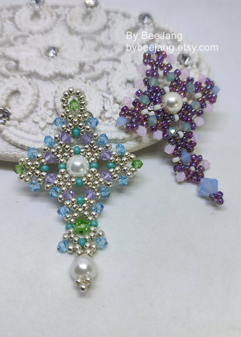 Chrisia pendants in two colors. One is in silver, green peridot and light blue. The other is in purple, blue, pink and pacific opal.