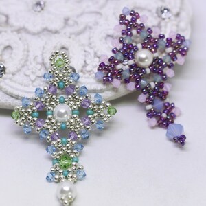 Chrisia pendants in two colors. One is in silver, green peridot and light blue. The other is in purple, blue, pink and pacific opal.