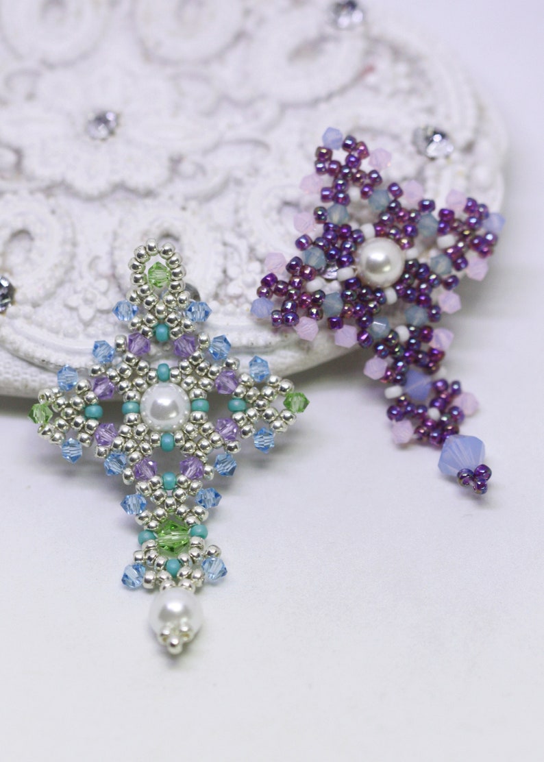 Chrisia pendants in two colors. One is in silver, green peridot and light blue. The other is in purple, blue, pink and pacific opal.