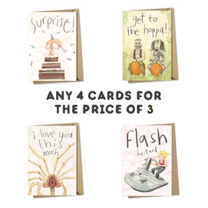 May include: Four illustrated greeting cards with humorous designs. The cards feature a shrimp on a cake, two figures riding on pumpkins, a creature with many legs, and a person riding a spaceship. The text on the cards reads "Surprise!", "Get to the hoppa!", "I love you this much", and "Flash bastard". The cards are offered as a deal: "Any 4 cards for the price of 3".