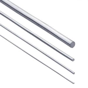 May include: A close-up of four shiny, silver metal rods of varying thicknesses. The rods are cylindrical and appear to be made of stainless steel or a similar material. The rods are angled diagonally across the frame.