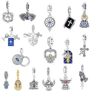 May include: A selection of silver and gold-toned charm pendants with religious and spiritual themes. Designs include crosses, angels, hearts, and a bible. Some charms feature blue and red enamel details, and some have text.