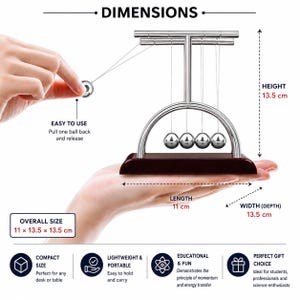 May include: A Newton's cradle with five polished silver metal balls suspended from a silver frame on a dark wood base. The device measures 13.5 cm in height, 11 cm in length, and 13.5 cm in width. Text labels indicate dimensions and usage instructions.