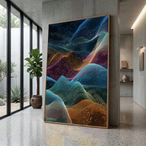 Op de afbeelding: Grote ingelijste abstracte kunstprint met een kleurrijk, golvend landschapsontwerp. Het kunstwerk toont een verloop van blauw, oranje, paars en groen, wat een levendige en moderne esthetiek creëert. De print wordt getoond in een eigentijds interieur.