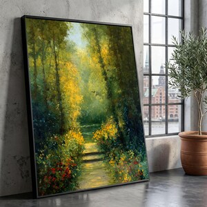 May include: A framed landscape painting of a forest path bathed in sunlight. The artwork uses greens, yellows, and reds, with a path leading into the distance. The painting is displayed against a grey wall, near a window and a potted plant.